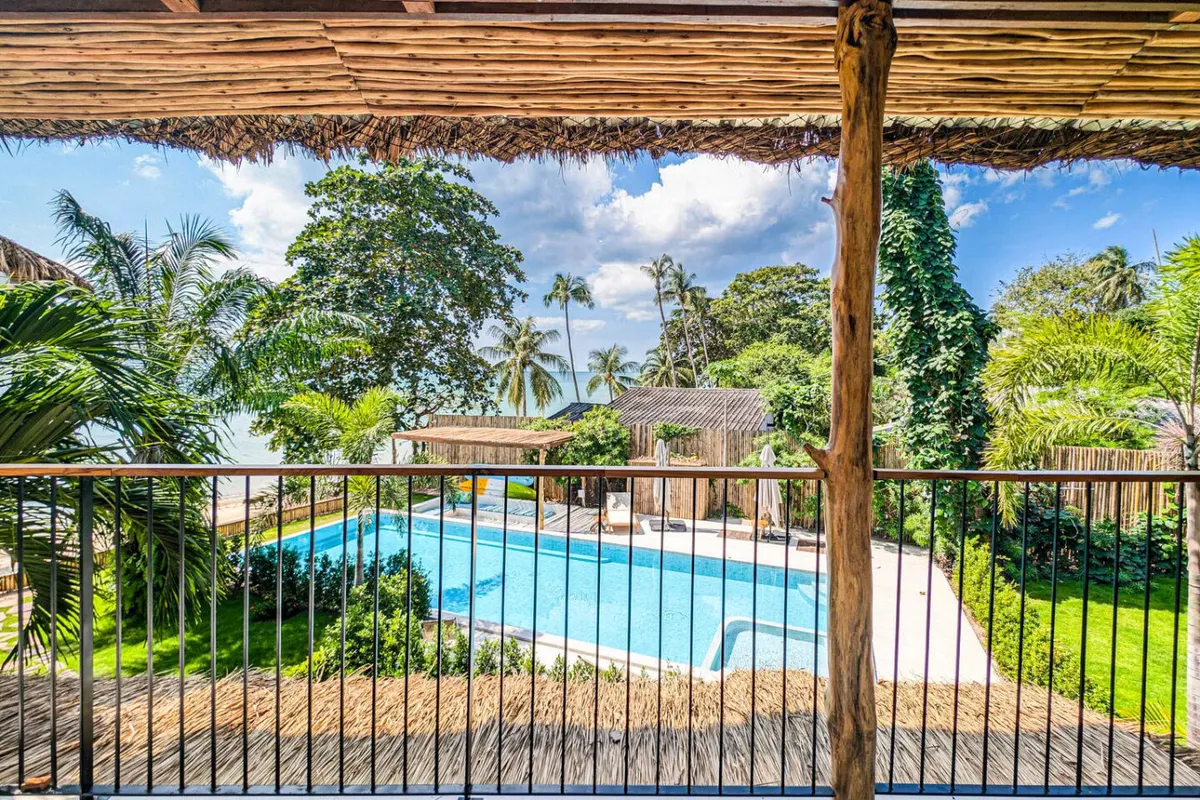 Baan Tai Beachfront Dream, Baan Tai — shared pool viewed from a covered balcony — Crazy GAKKO Stay