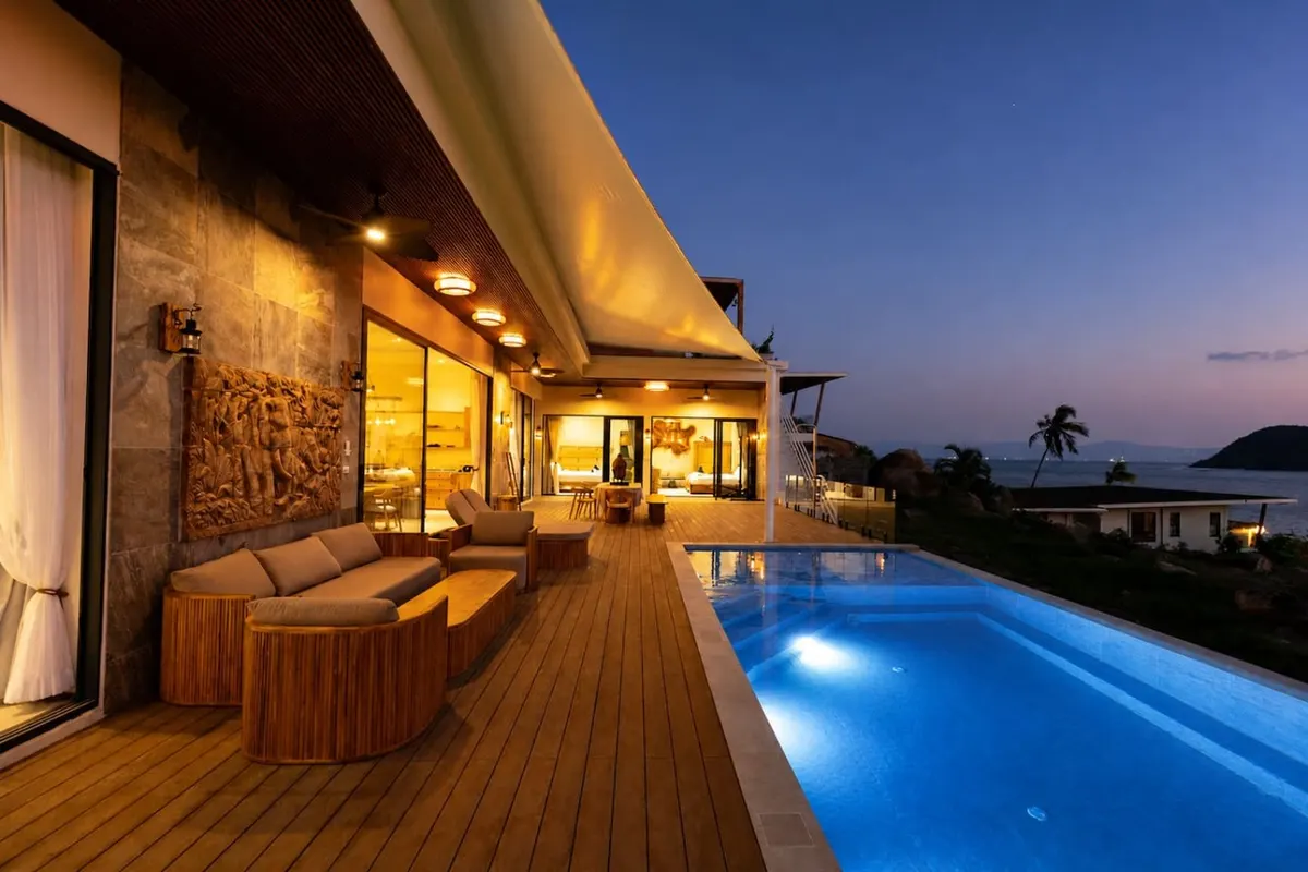 Beachfront Villa Lotus, Nai Wok — pool deck beside the sea at dusk — Crazy GAKKO Stay