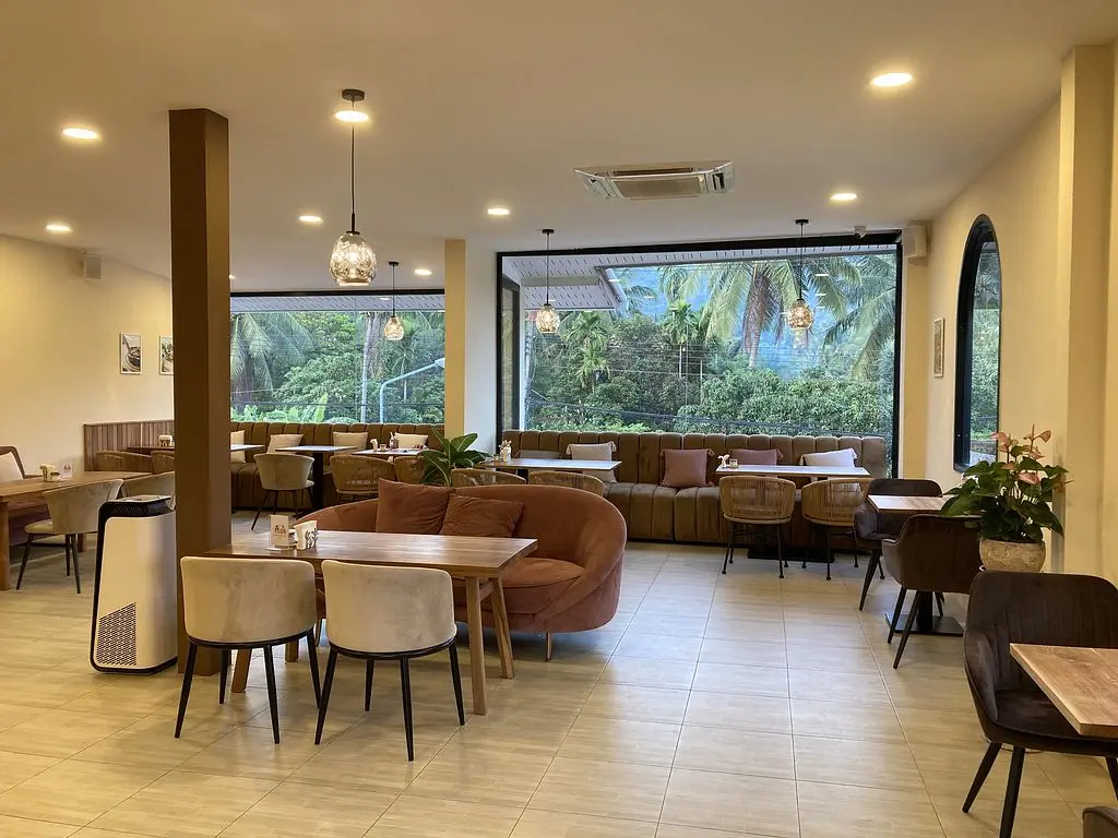 The bright, plant-filled interior at Deli Devi in Koh Phangan