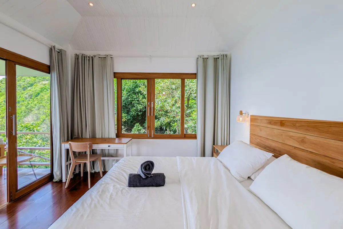 Samathí Oceanfront Retreat, Northern Koh Phangan — bedroom surrounded by tropical trees — Crazy GAKKO Stay