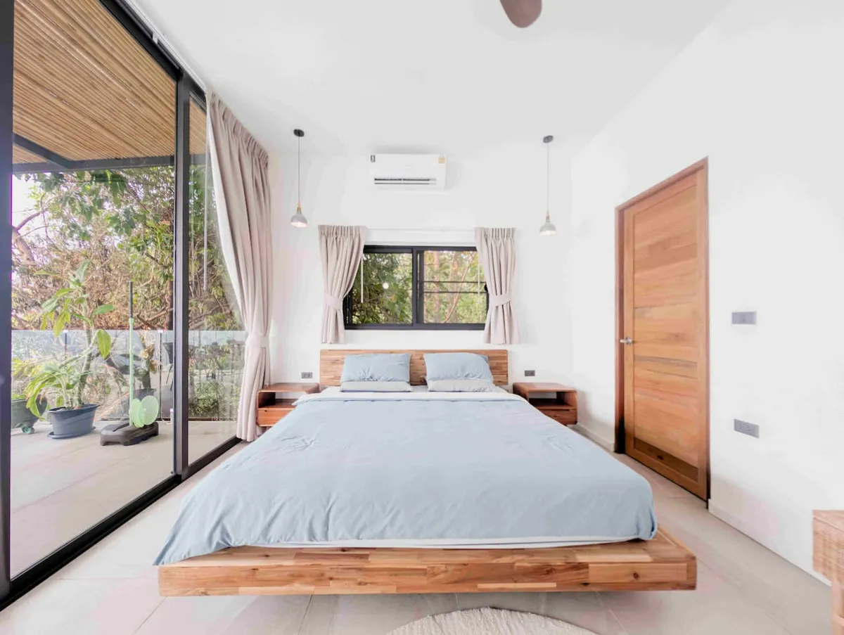 The Serenity Villa, Haad Yao — guest bedroom with garden-facing doors — Crazy GAKKO Stay