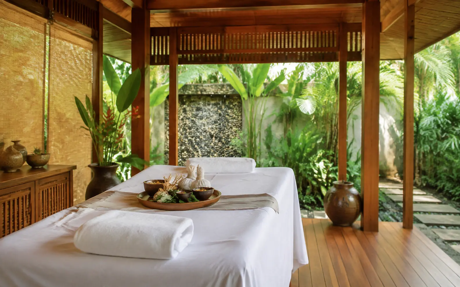 Illustration: massage beds and spa accessories in a tropical treatment room