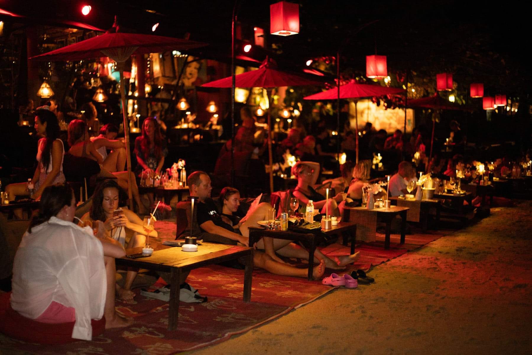 Low tables and lanterns on the beach at L’Alcove in Hin Kong